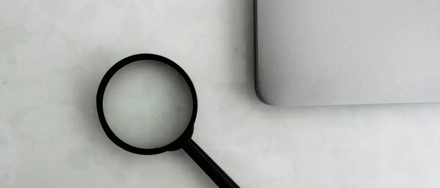 Lupe neben einem Laptop
